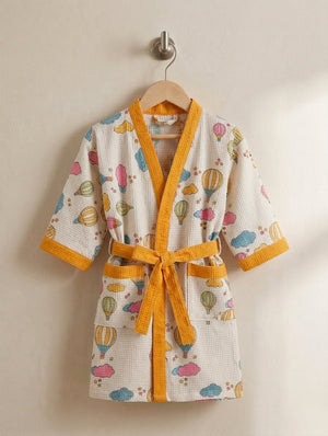Children's robe with hot air balloon pattern on a beige background