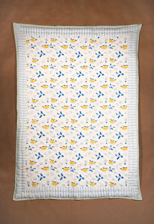 baby quilt with repeated motif of helicopter and aeroplane.