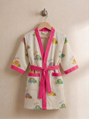 Children's bathrobe with colorful elephant patterns and pink trim on a beige background